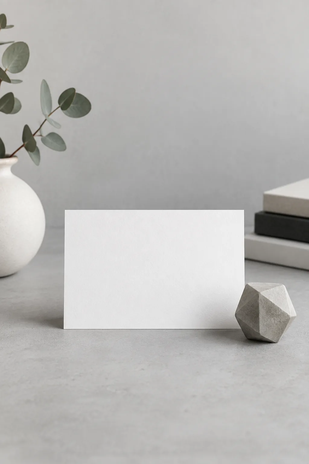 Illustration of a clean minimalist card on a plain desk beside a single sprig